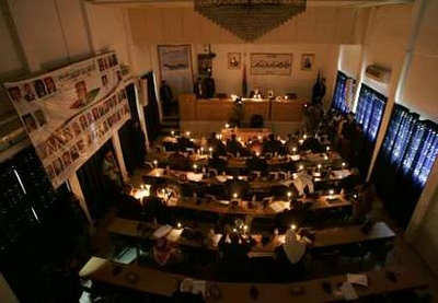 Palestinian lawmakers attend a parliament session in candlelight during a power cut in Gaza January 22, 2008. Israel agreed to allow some fuel, medicine and food into the Hamas-run Gaza Strip on Tuesday, at least temporarily easing a blockade that has plunged much of the territory into darkness and sparked international protests. REUTERSMohammed Salem (GAZA)